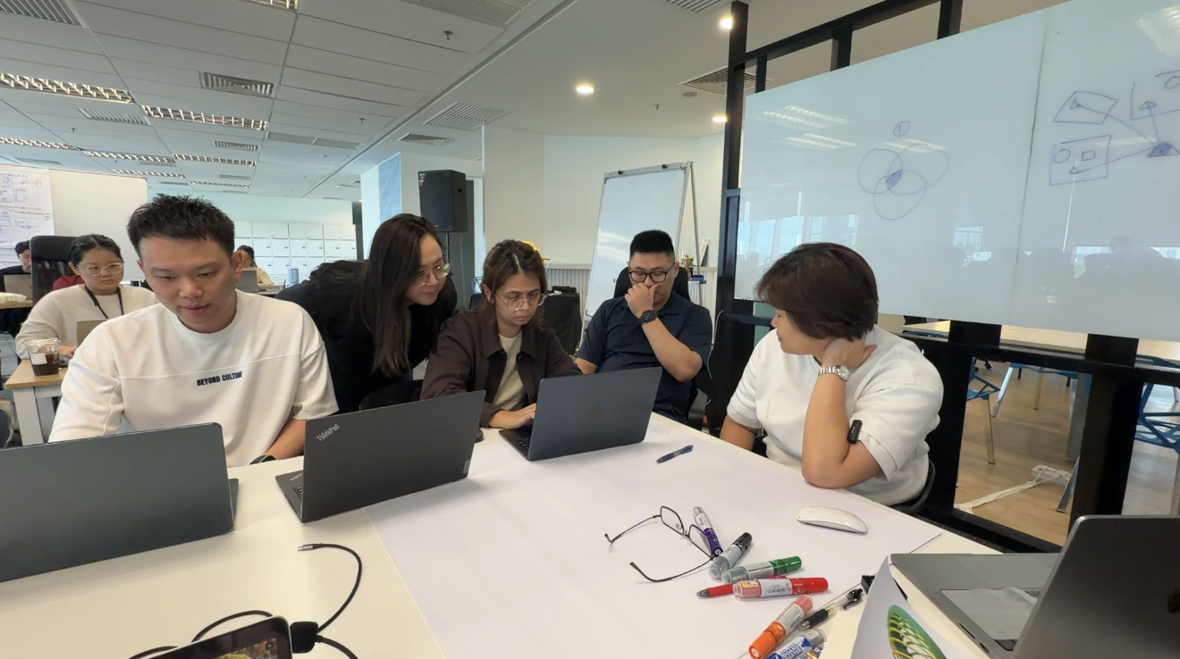 Participants working together with laptops during a CST workshop
